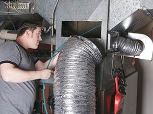 technician performing Air Duct Cleaning in Cumming, GA, Marietta, Atlanta, Suwanee, Lawrenceville, Decatur and Nearby Cities